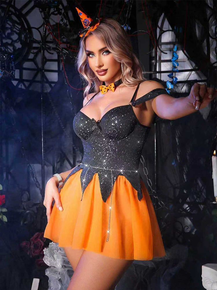 Woman wearing a black and orange Halloween witch glitter babydoll costume dress with hat headband