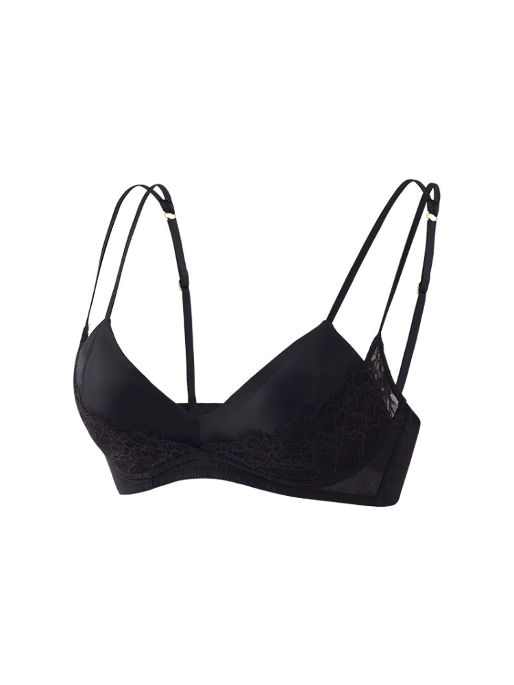 Angled view of a black silk and lace bra featuring smooth V-shaped cups, floral lace panels, and adjustable double shoulder straps.