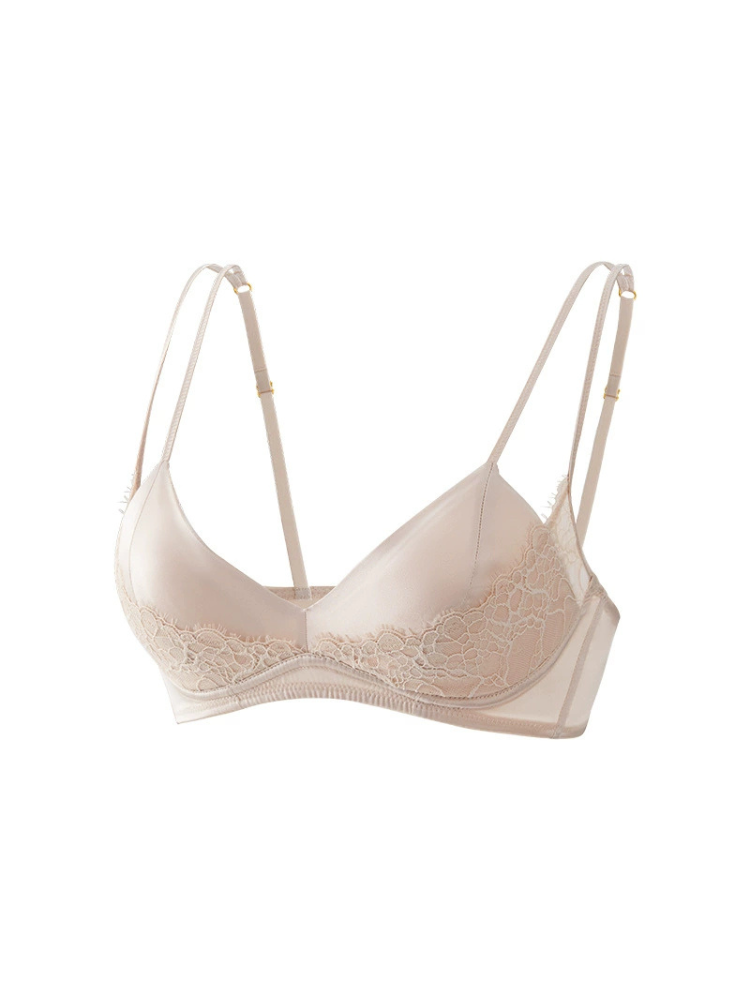 Angled view of a champagne-colored silk bra with floral lace along the lower cups, double shoulder straps, and a smooth finish.