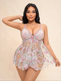 Plus size woman wearing a pink floral embroidered sheer mesh babydoll dress with matching panty