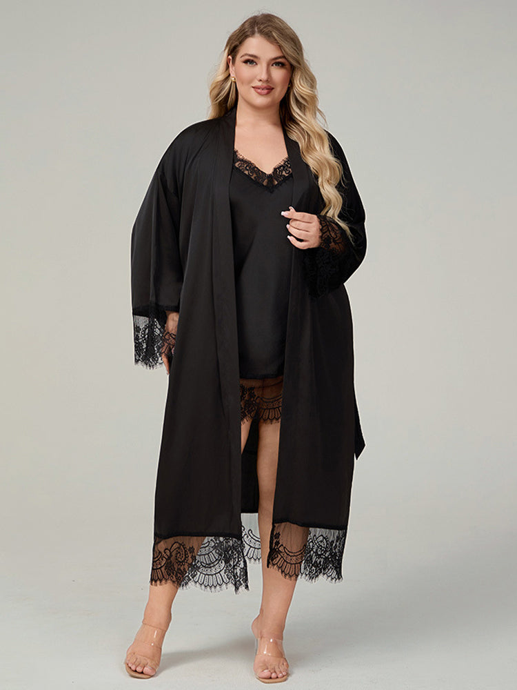 Plus size woman wearing 2 piece black satin robe and lace trimmed chemise dress set