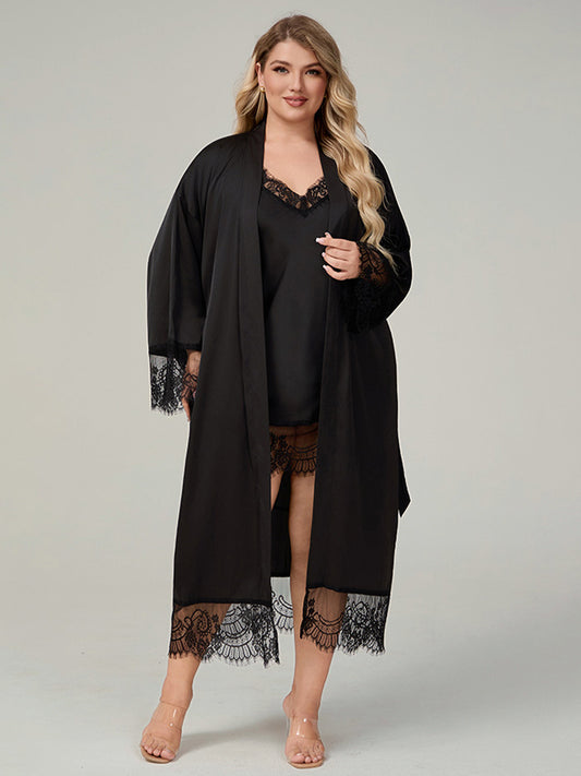 Plus size woman wearing 2 piece black satin robe and lace trimmed chemise dress set