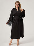 Plus size woman wearing black satin kimono robe with vertical lace back panel and lace cuffs