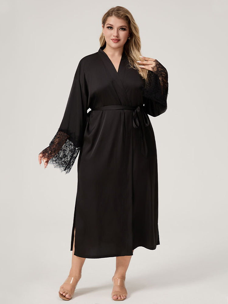 Plus size woman wearing black satin kimono robe with vertical lace back panel and lace cuffs