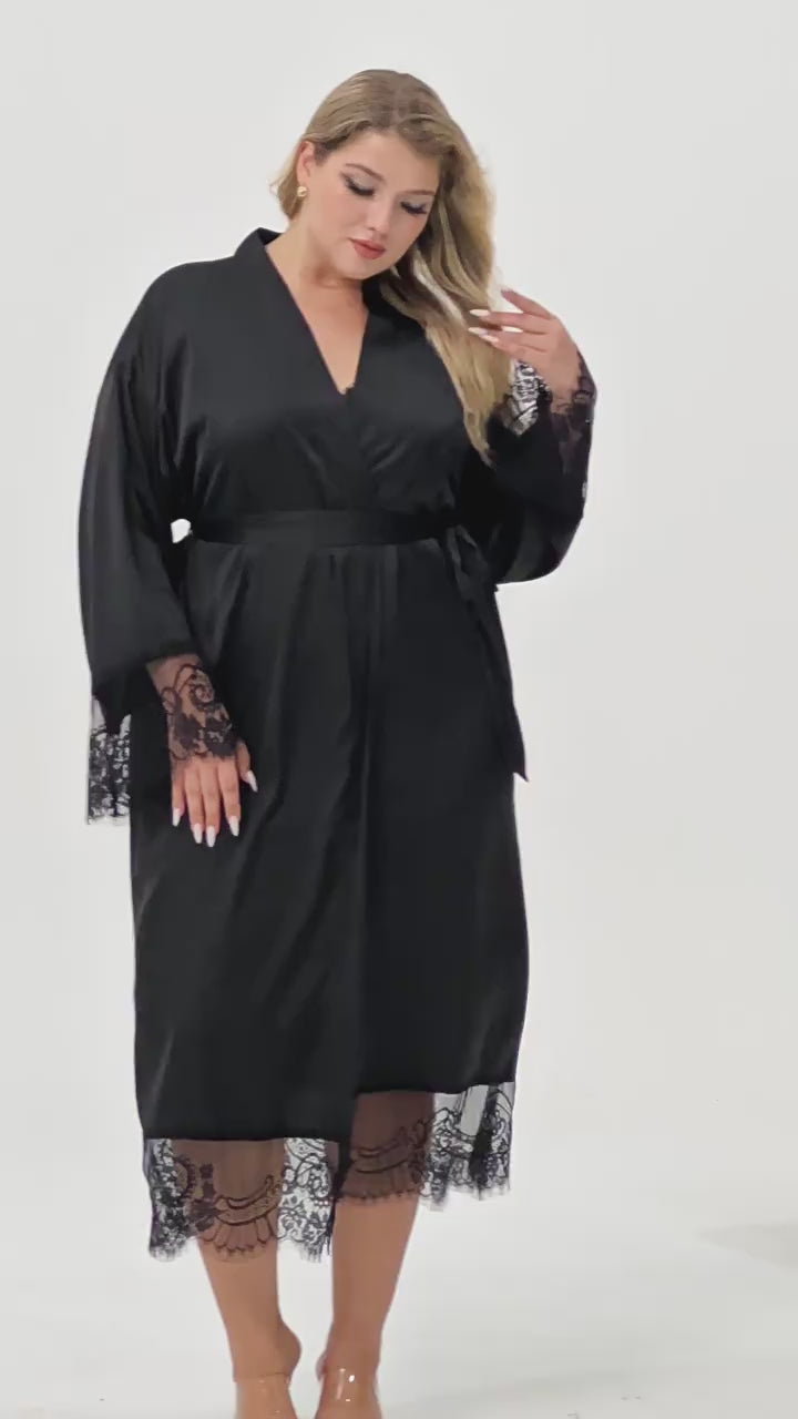 Plus size woman wearing 2 piece black satin robe and lace trimmed chemise dress set