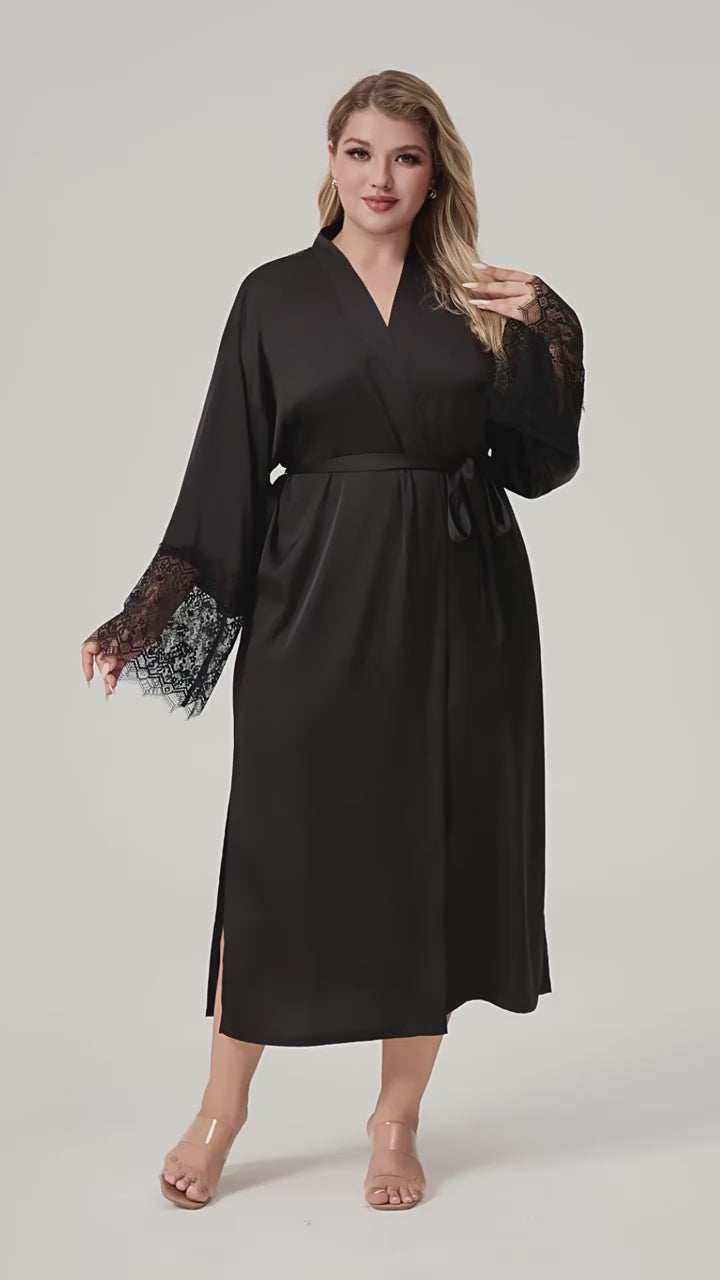 Plus size woman wearing black satin kimono robe with vertical lace back panel and lace cuffs