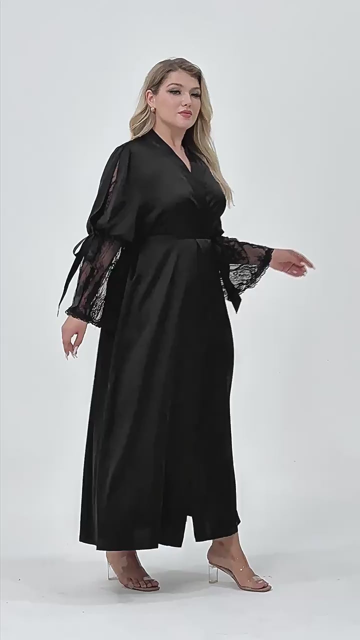 Plus size woman wearing 2 piece black satin robe and side slit criss cross back slip dress set