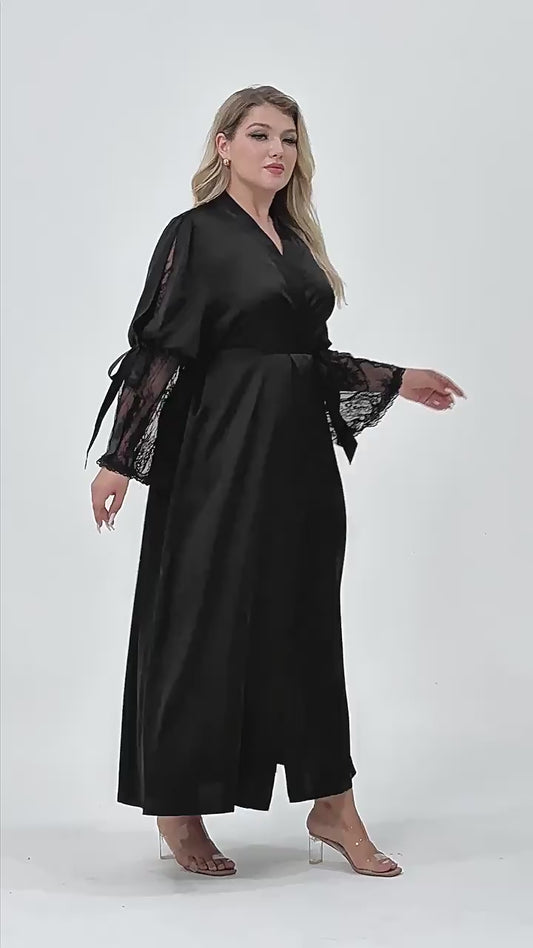 Plus size woman wearing 2 piece black satin robe and side slit criss cross back slip dress set